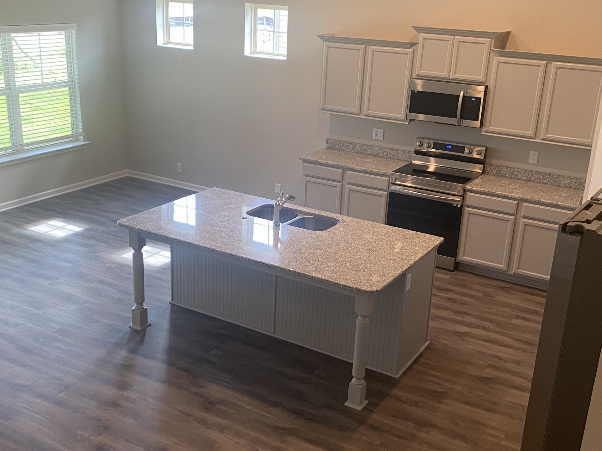 247 Ruby Cate Way Murfreesboro, TN 37128 - Photo 5 of 10 a kitchen with granite countertop a stove and a sink