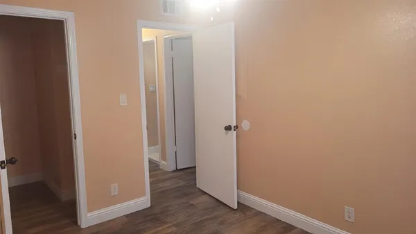 an empty room with wooden floor