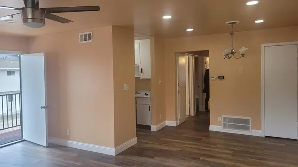 a view of a hallway with wooden floor