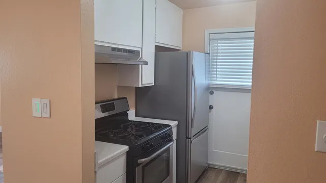a kitchen with a stove and a refrigerator