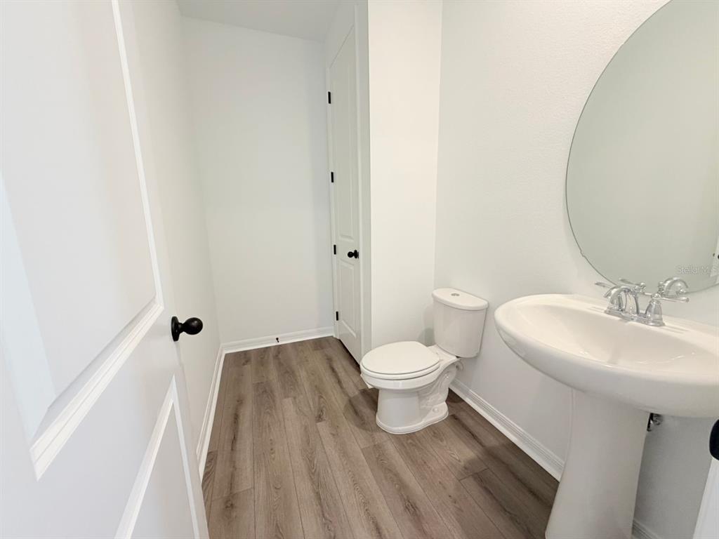 30155 Rustic Mill St Mount Mount Dora, FL 32757 - Photo 12 of 20 a white toilet sitting next to a bathroom sink