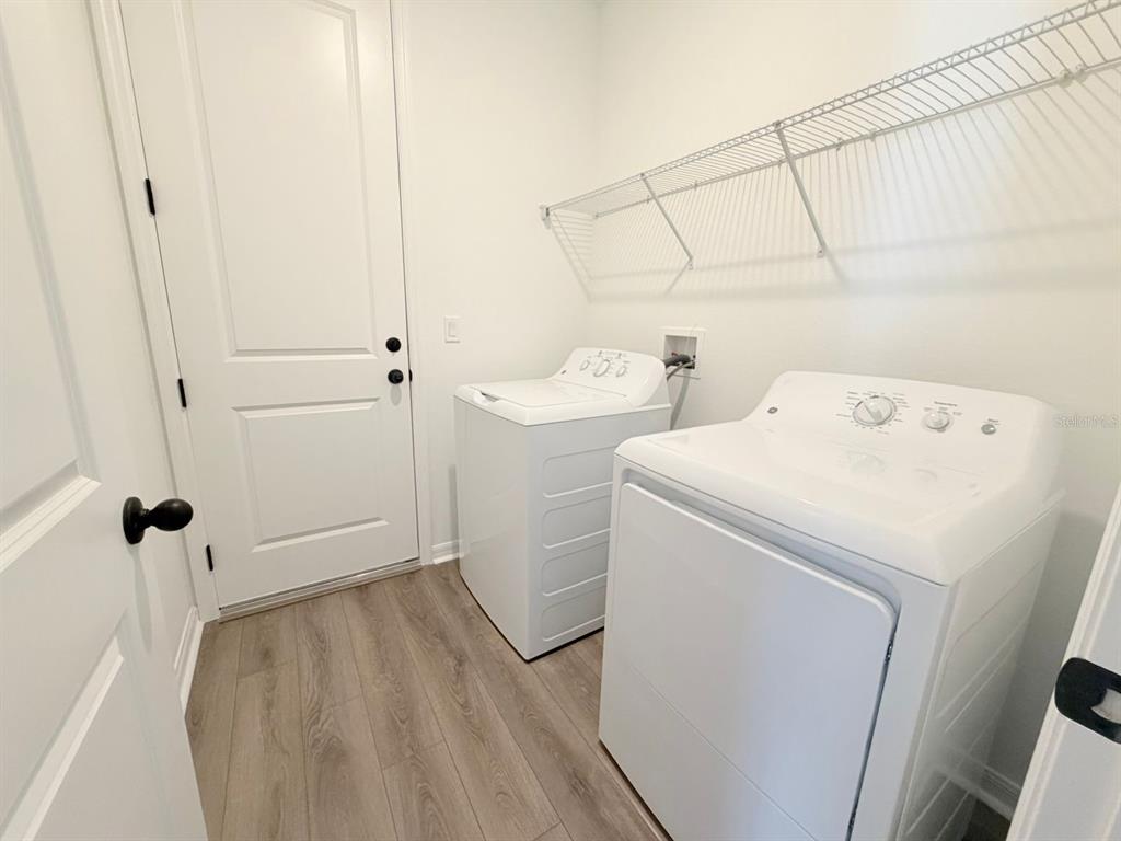 30155 Rustic Mill St Mount Mount Dora, FL 32757 - Photo 18 of 20 a view of storage and utility room with washer and dryer