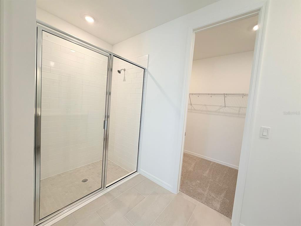 30155 Rustic Mill St Mount Mount Dora, FL 32757 - Photo 20 of 20 a bathroom with a glass shower door