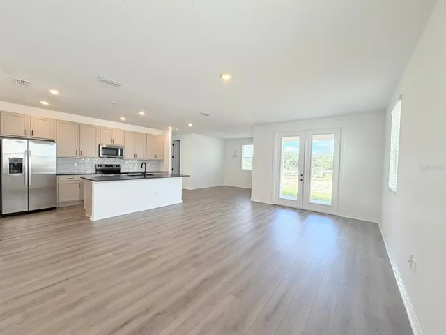 a view of kitchen with wooden floor and windows