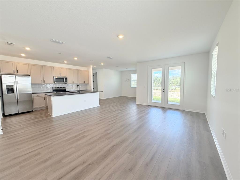 30155 Rustic Mill St Mount Mount Dora, FL 32757 - Photo 5 of 20 a view of kitchen with wooden floor and electronic appliances