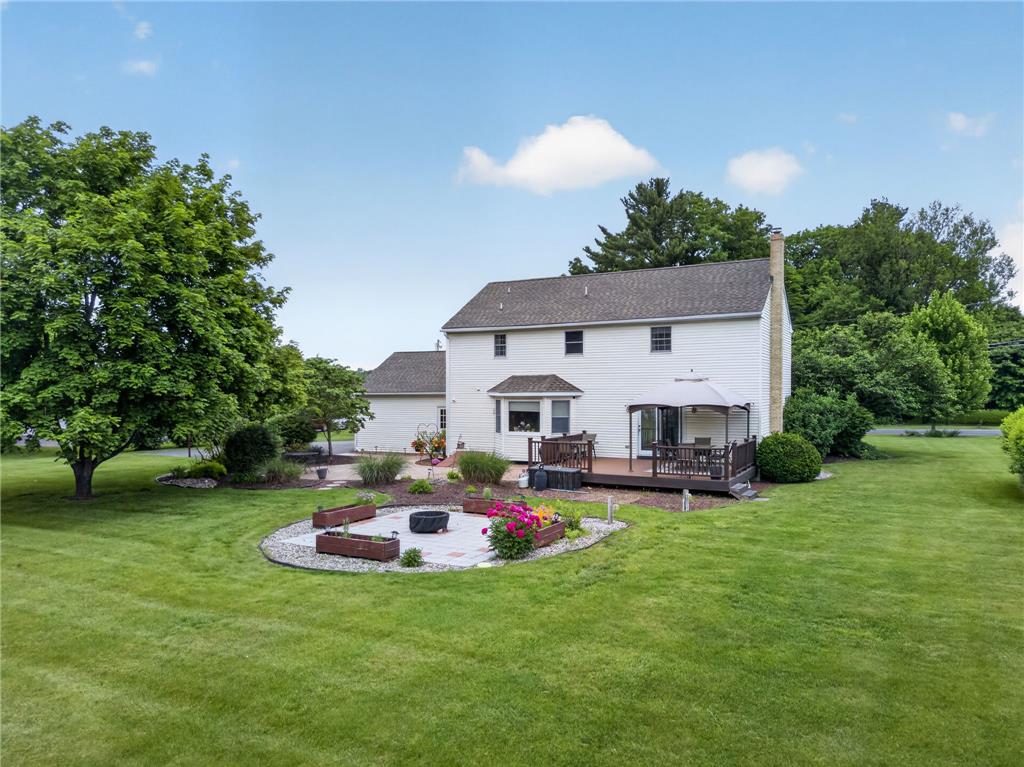 853 Lahr Road Nazareth, PA 18064 - Photo 27 of 29 A spacious yard boasts a delightful deck and patio with a fire pit, perfect for outdoor living.
