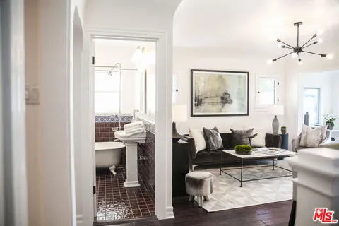 a kitchen with stainless steel appliances a refrigerator sink and stove