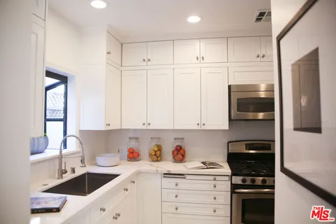 a view of a refrigerator and a couch in a kitchen