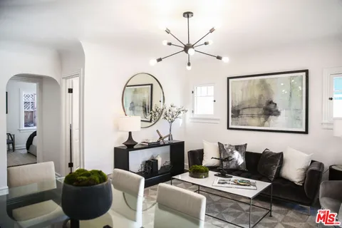 a living room with furniture and potted plant