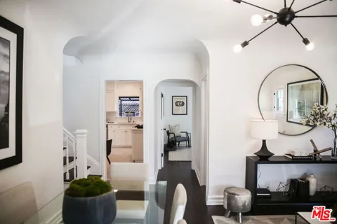 a living room with furniture a fireplace and a chandelier