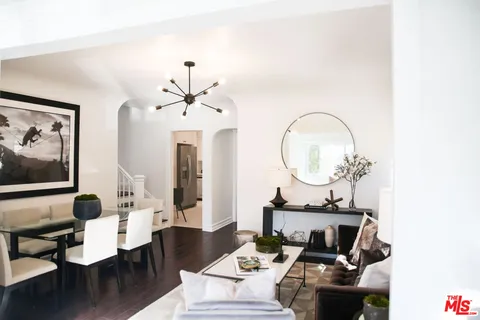 a living room with furniture and a ceiling fan