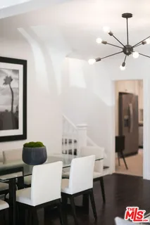 a living room with furniture and a mirror