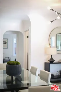 a living room with furniture a table and white walls