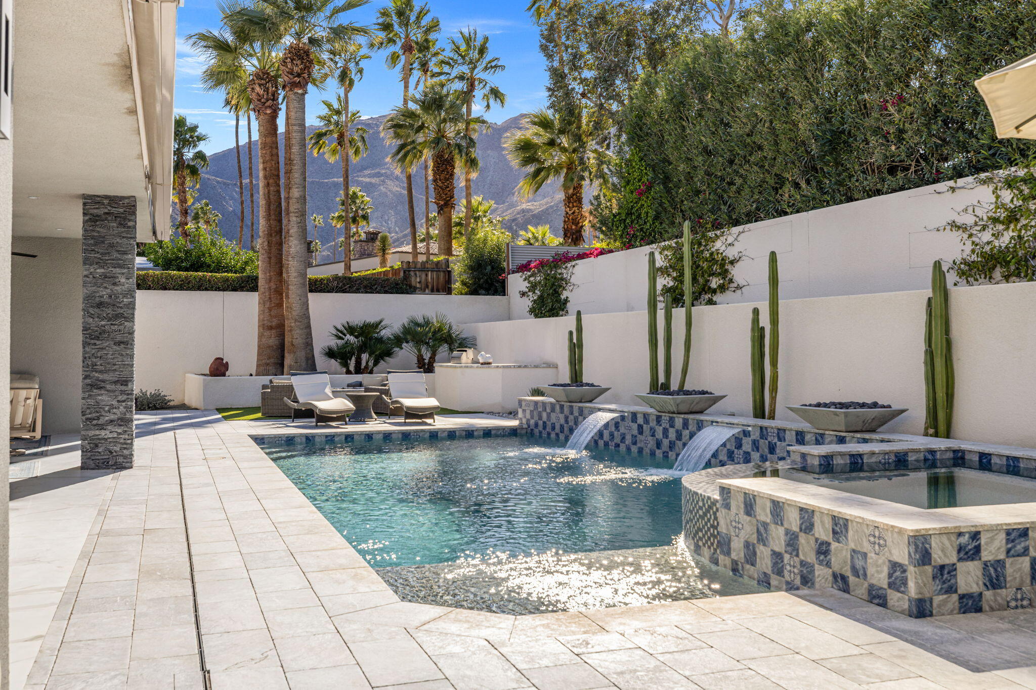 a view of swimming pool with outdoor seating and plants