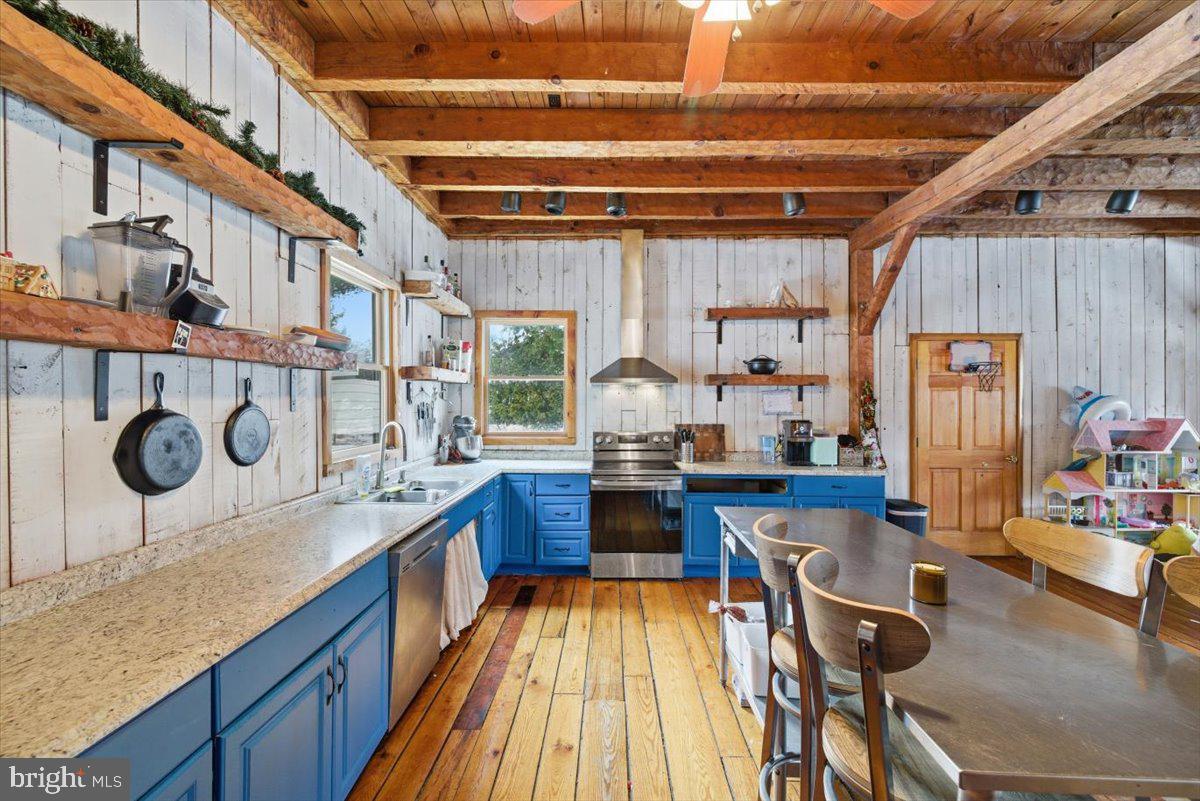 159 Colony Villiage Cresco, PA 18326 - Photo 26 of 105 a kitchen with stainless steel appliances granite countertop a sink a stove and a wooden floors