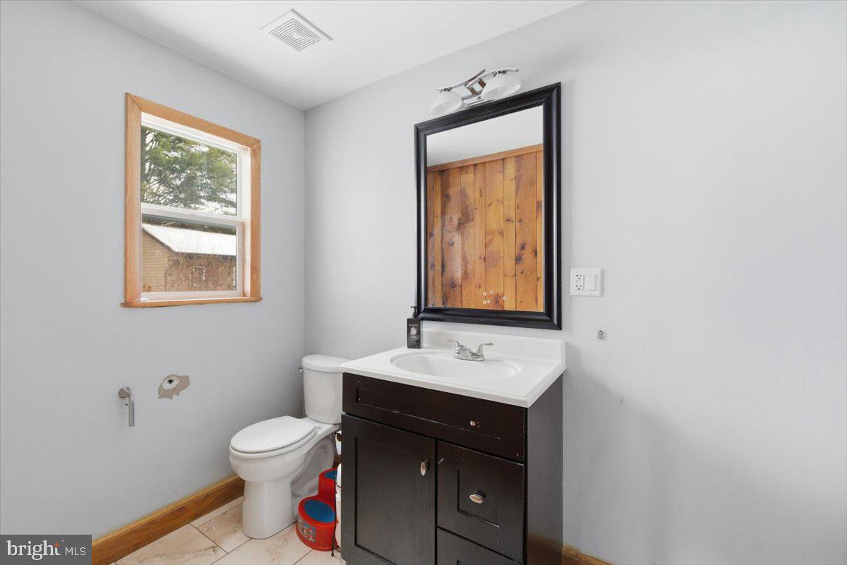159 Colony Villiage Cresco, PA 18326 - Photo 29 of 105 a bathroom with a toilet sink vanity and mirror
