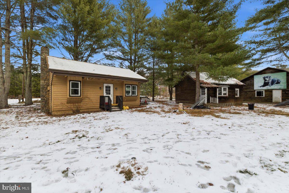 159 Colony Villiage Cresco, PA 18326 - Photo 42 of 105 a front view of a house with a yard covered with snow