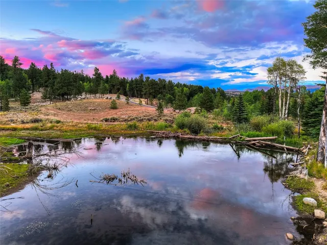 a view of residential houses with outdoor space and lake view