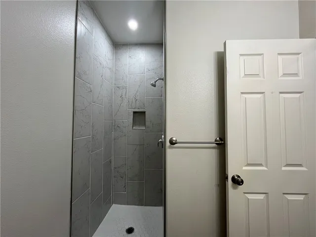 a bathroom with a glass shower door