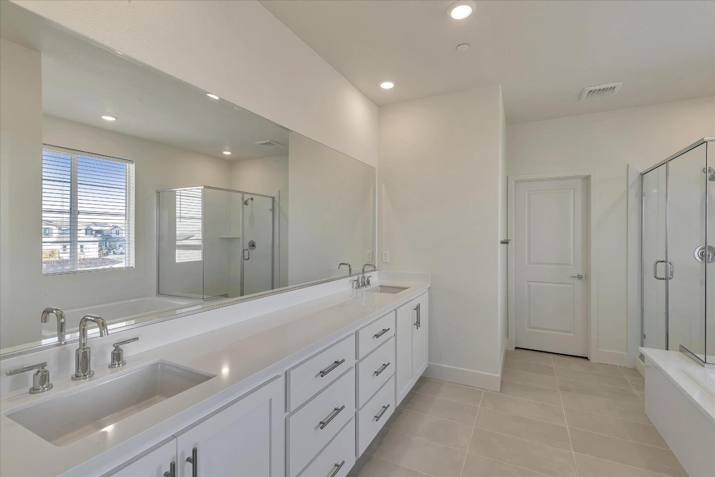 5459 Posner Avenue Tracy, CA 95377 - Photo 22 of 29 a spacious bathroom with double vanity a mirror and a shower