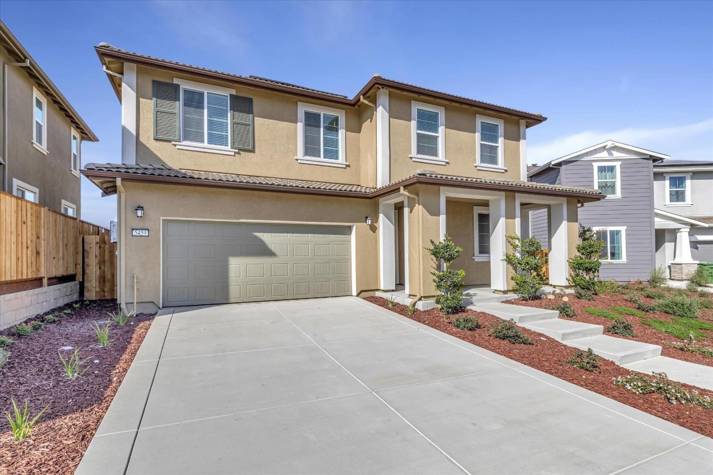 5459 Posner Avenue Tracy, CA 95377 - Photo 3 of 29 a front view of a house with a yard and a garage