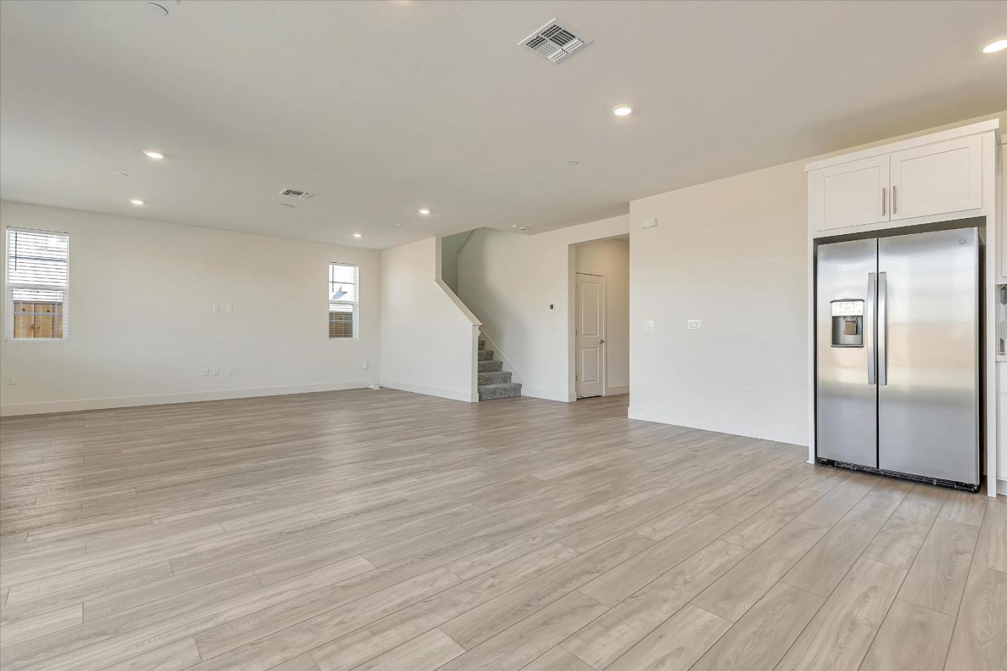 5459 Posner Avenue Tracy, CA 95377 - Photo 5 of 29 an empty room with wooden floor and windows
