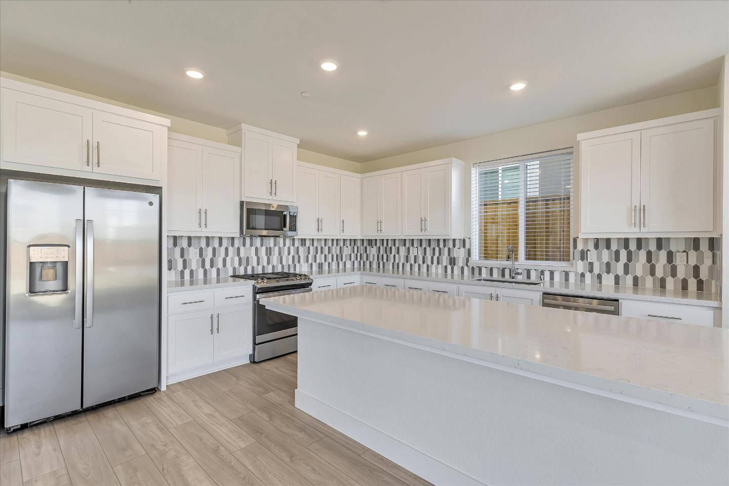 5459 Posner Avenue Tracy, CA 95377 - Photo 9 of 29 a large kitchen with granite countertop a large counter top stainless steel appliances and cabinets