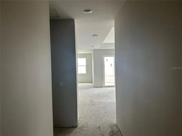 a view of a hallway to an empty room