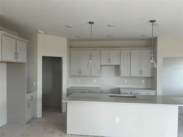 a kitchen with stainless steel appliances granite countertop a sink and white cabinets