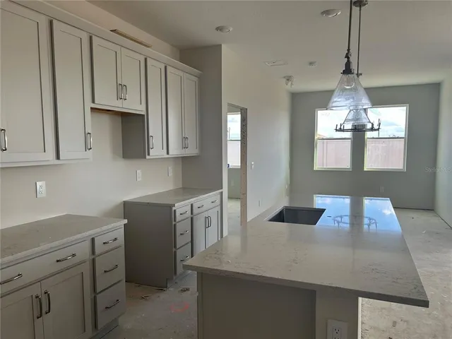 a kitchen with cabinets appliances and a counter space
