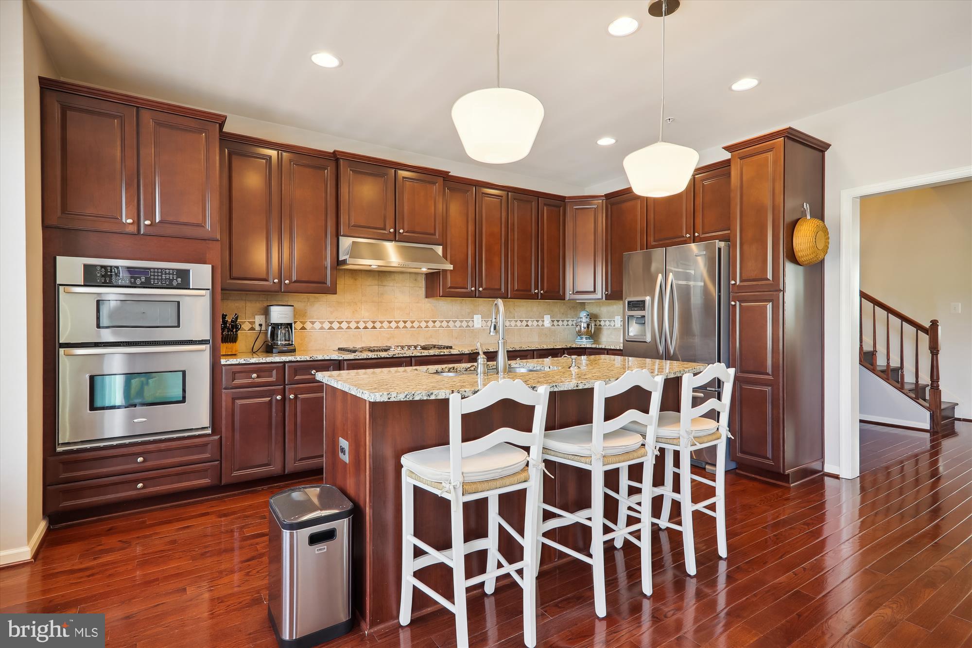 1609 Poplar Run Drive Silver Spring, MD 20906 - Photo 26 of 71 a kitchen with stainless steel appliances wooden cabinets a stove and a refrigerator