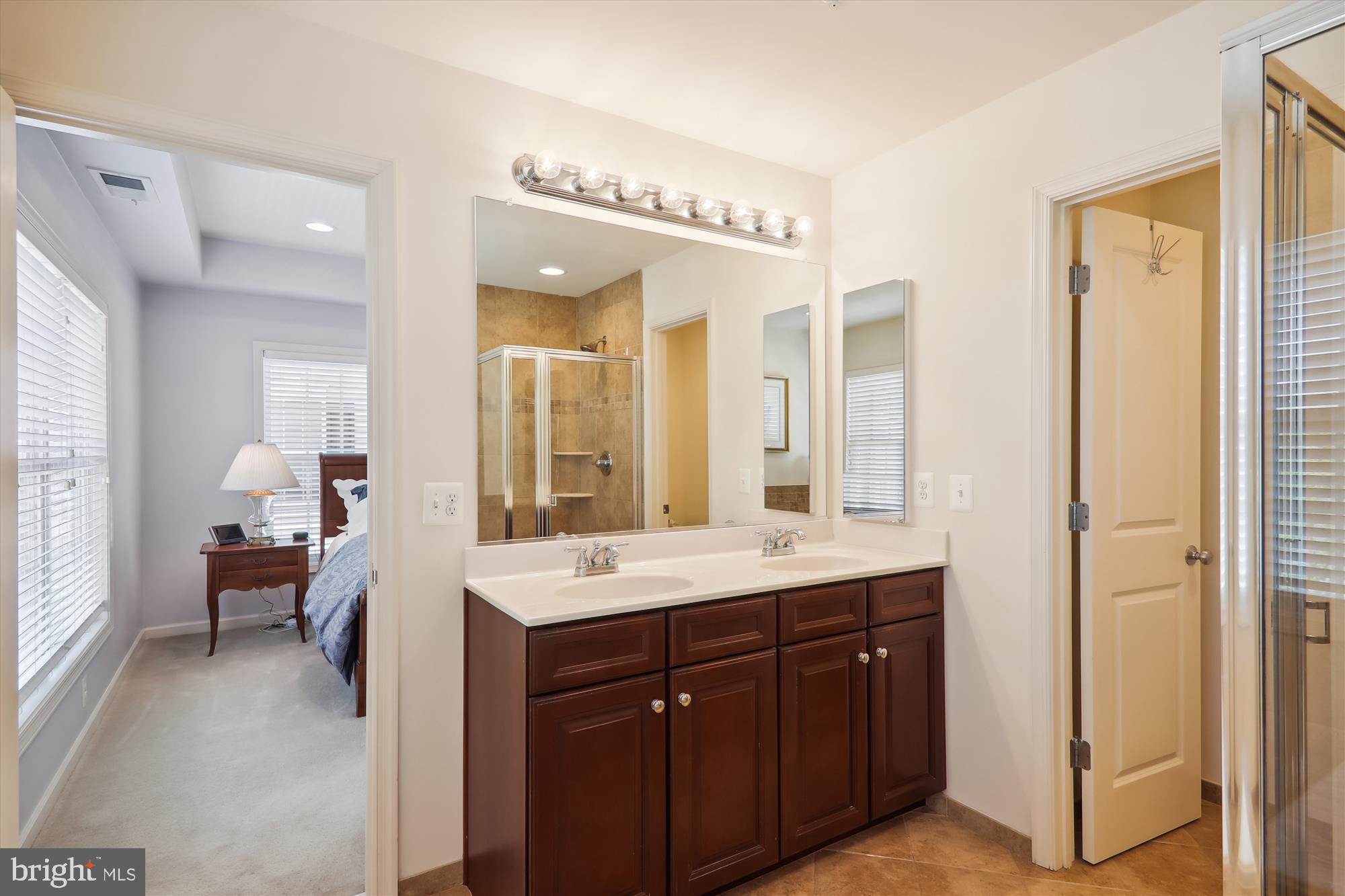 1609 Poplar Run Drive Silver Spring, MD 20906 - Photo 40 of 71 a en suite bathroom with a double vanity sink a mirror and a shower