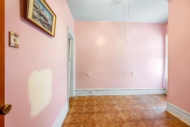 an empty room with a window and a ceiling fan