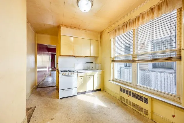 a kitchen with a stove a sink and a refrigerator