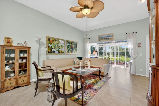 a living room with furniture a chandelier and a large window