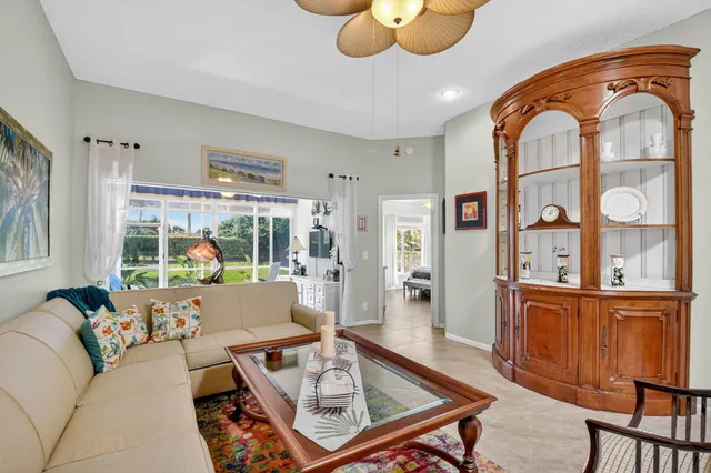 a living room with furniture or chandelier and a wooden floor
