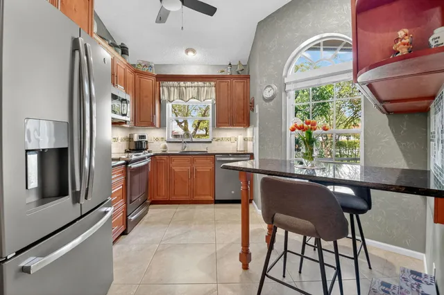 a view of a dining room with furniture and a chandelier