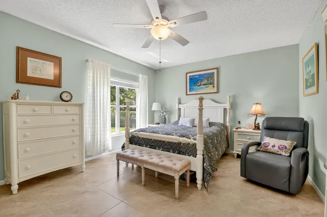 a bedroom with a bed dresser and a window