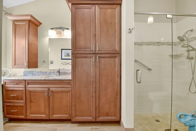 a bathroom with a toilet shower and a mirror