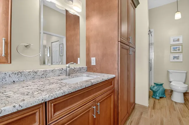 a bedroom with a bed a couch and a chandelier