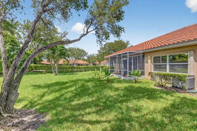 an aerial view of a house with a garden and lake view