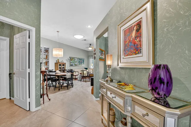 a view of a dining room with furniture and chandelier