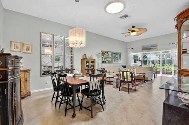 a view of a dining room with furniture and chandelier