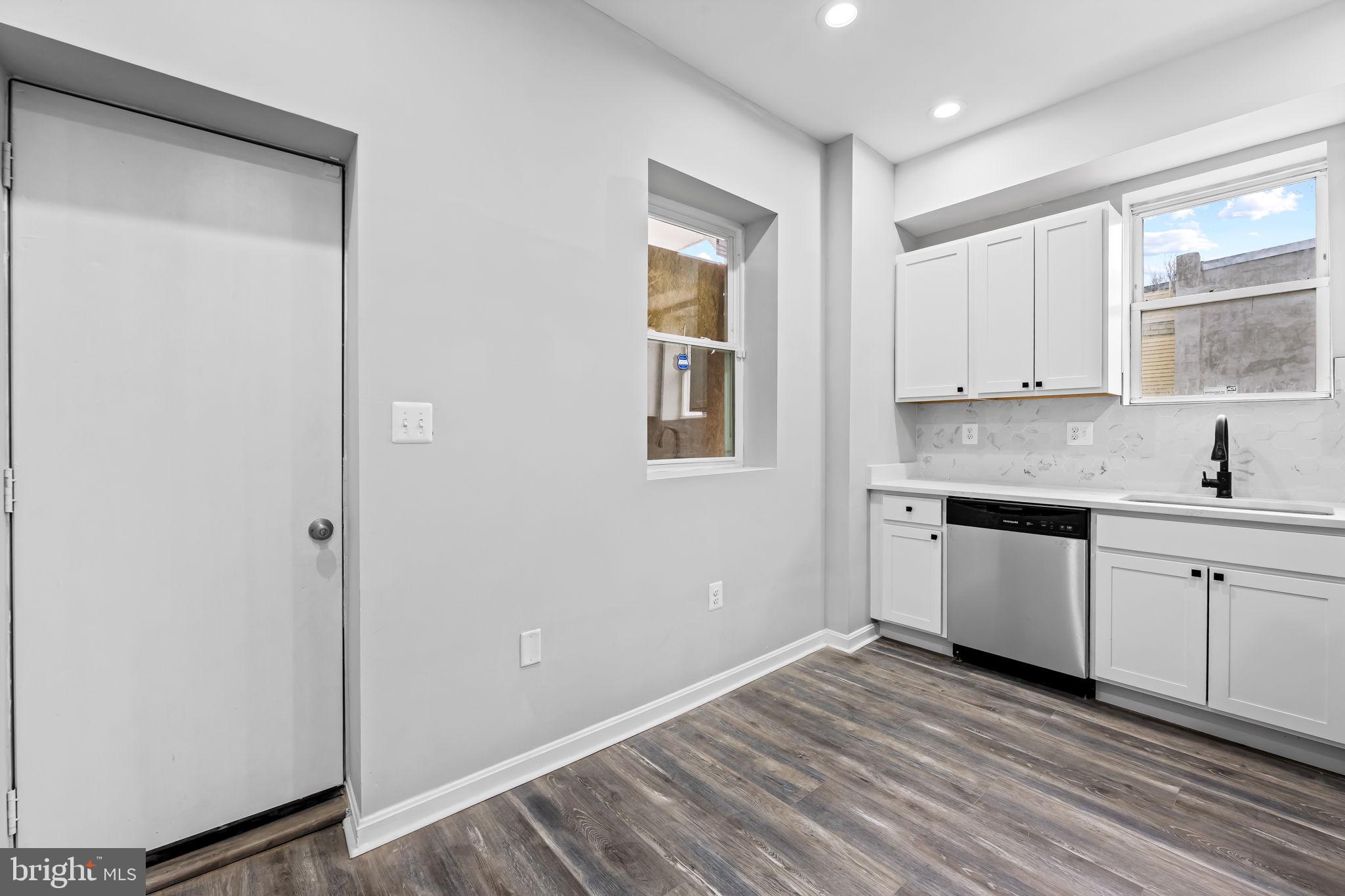 1918 East Lafayette Avenue Baltimore, MD 21213 - Photo 12 of 30 a kitchen with a sink window and cabinets