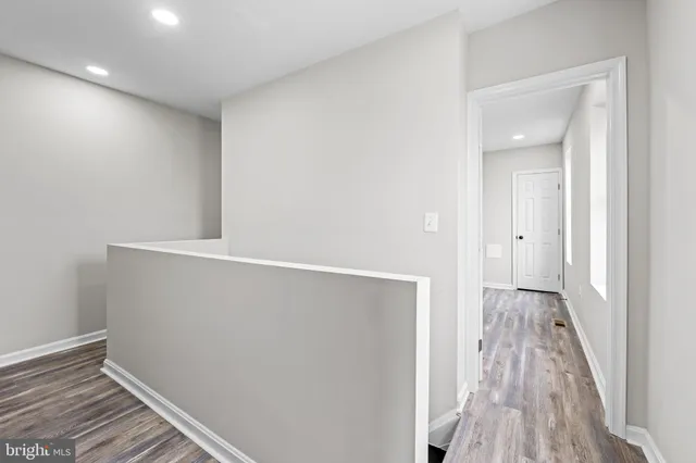 a view of hallway with wooden floor