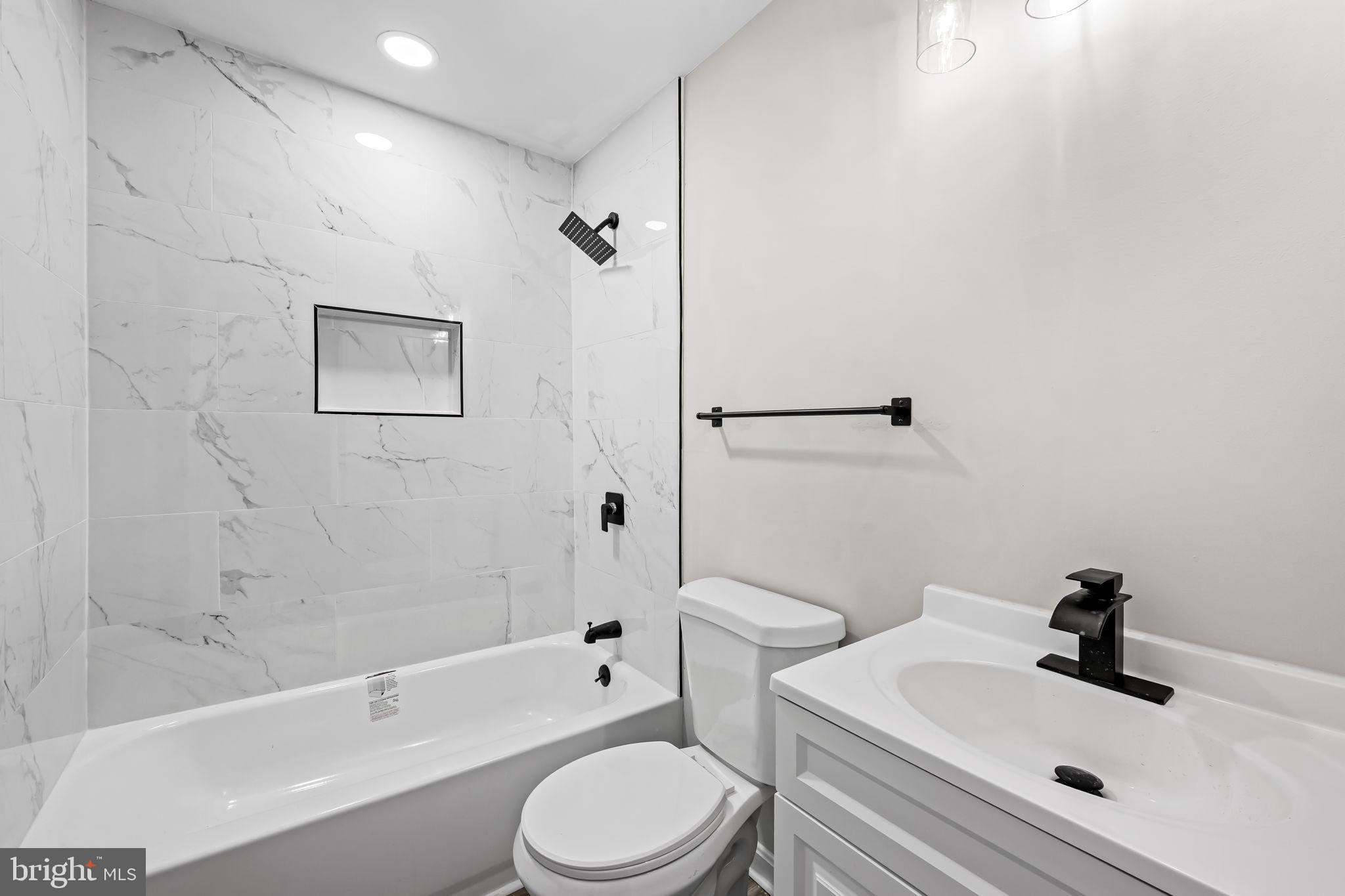 1918 East Lafayette Avenue Baltimore, MD 21213 - Photo 20 of 30 a bathroom with a sink toilet and shower