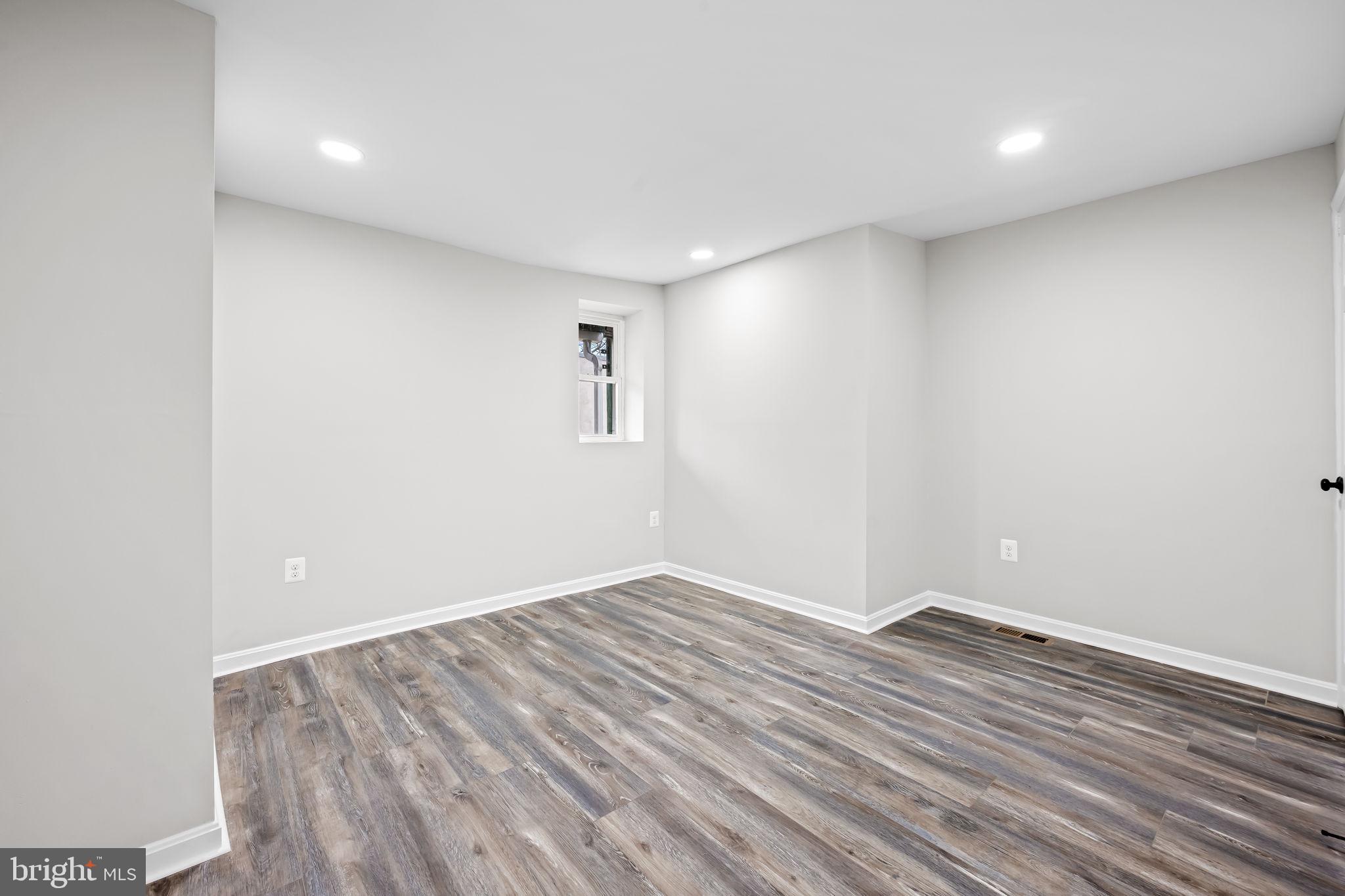 1918 East Lafayette Avenue Baltimore, MD 21213 - Photo 21 of 30 a view of room with wooden floor and white walls