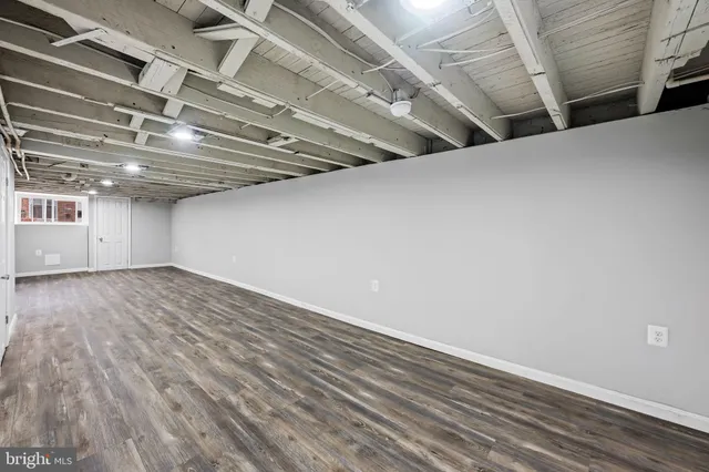 a view of a room with wooden floor