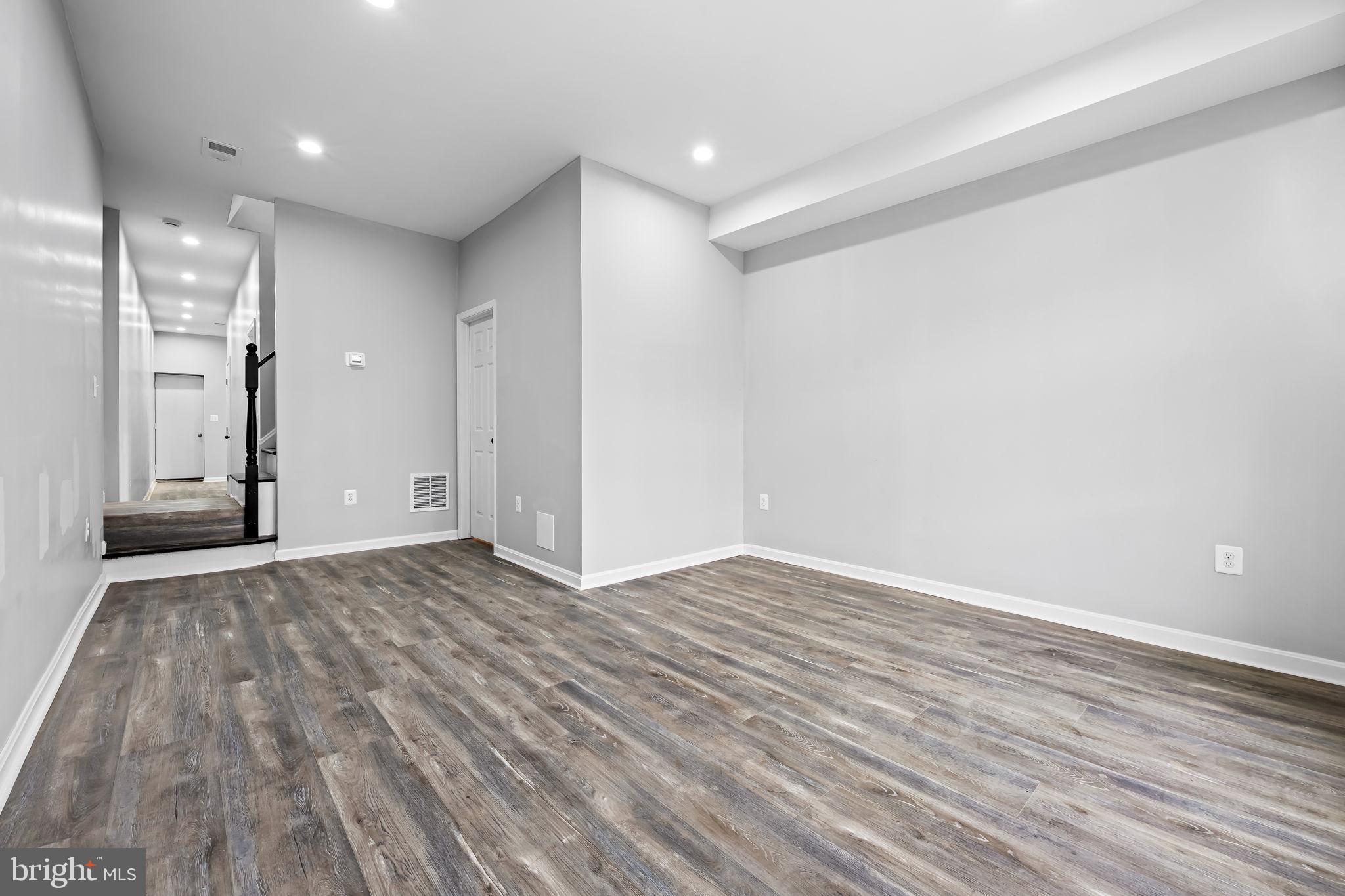 1918 East Lafayette Avenue Baltimore, MD 21213 - Photo 4 of 30 a view of an empty room with wooden floor and closet