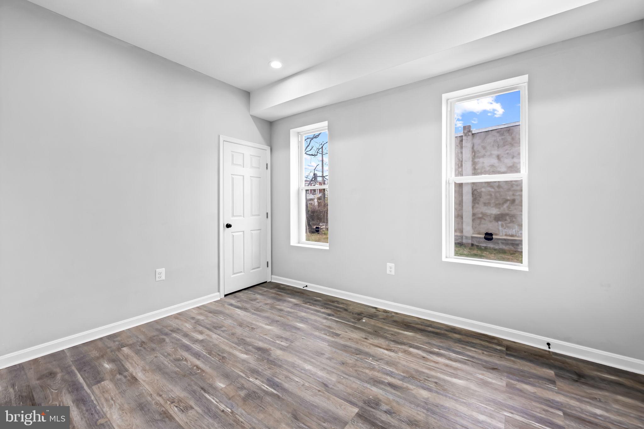 1918 East Lafayette Avenue Baltimore, MD 21213 - Photo 7 of 30 a view of an empty room with wooden floor and a window